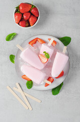 Refreshing Strawberry Popsicles, Ice Lolly with Fresh Strawberry and Mint on Bright Background