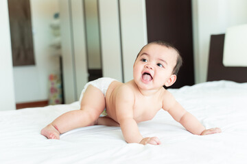 Baby smile, Little Boy lying on the bed, small child wandering.