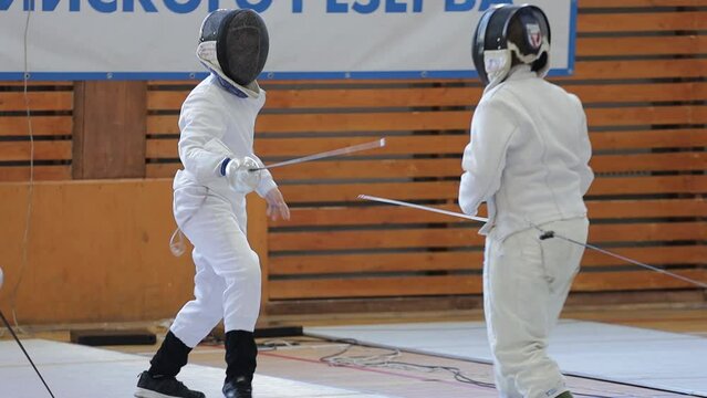Russia St. Petersburg 01.05.2023 two children fencing on foil in a sports club