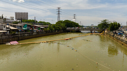 Polluted Ciliwung river with garbage in the slums of Jakarta, Indonesia.