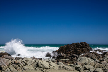 Rocky beach at Tsaarbank in West Coast national Park, Langebaan with waves crashing on the rocks.