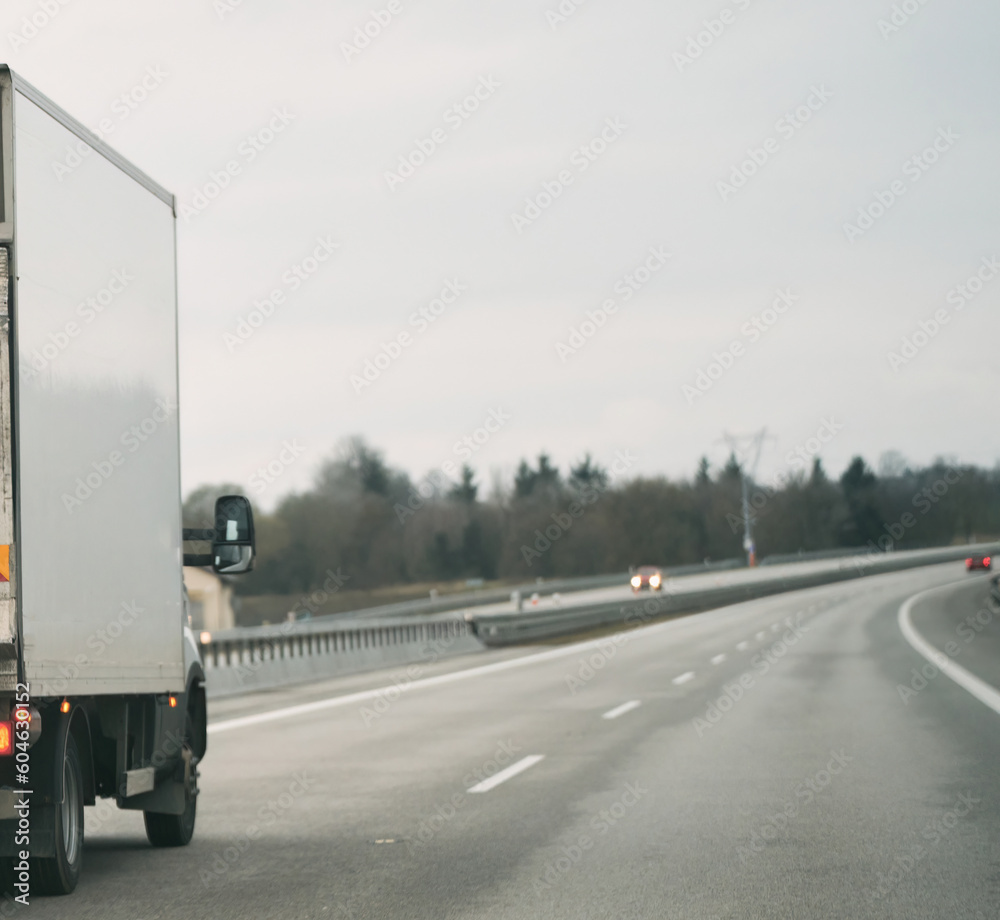 Wall mural truck with container on the highway, cargo transportation concept. a big truck moves on the highway 