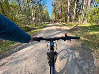 Fototapeta na wymiar POV bike handlebar closeup. Concept of riding a bicycle outdoors