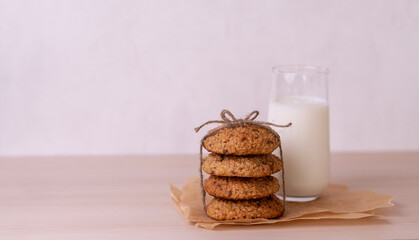 Healthy oatmeal cookies with chocolate chips and a glass of yogurt on the table