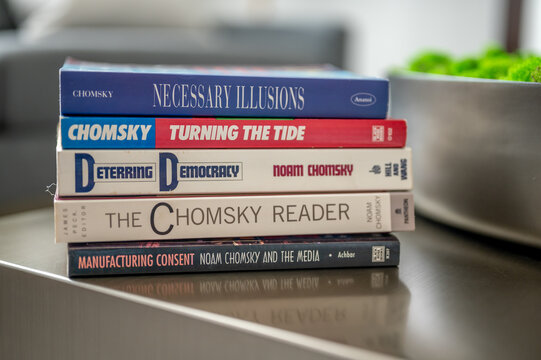 Calgary, Alberta - May 20, 2023: Stack of Noam Chomsky books on a table in a modern living room.