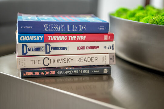 Calgary, Alberta - May 20, 2023: Stack of Noam Chomsky books on a table in a modern living room.