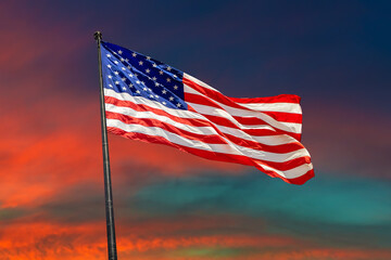USA flag waving against sunset sky