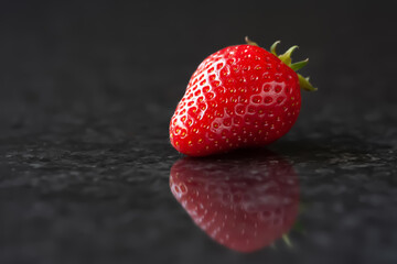 Strawberry. Red strawberries on a black background. Selective focus