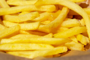 Fresh tasty fried french fries close up. Selective focus, defocus