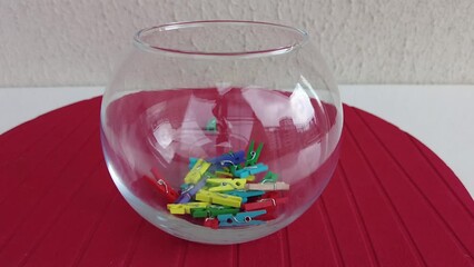 colorful pegs falling on red ground