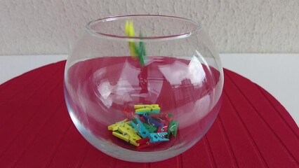 colorful pegs falling on red ground