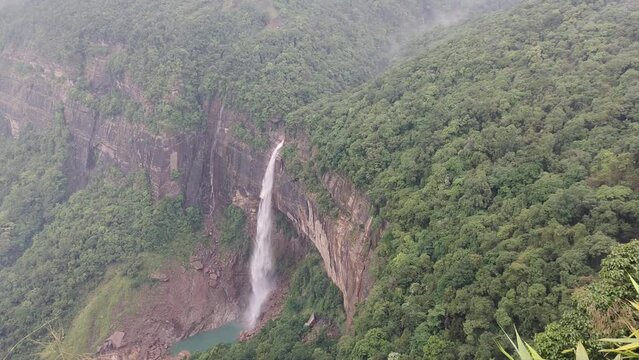 Nohkalikai Falls (Tallest Plunge Waterfall in India) in Cherrapunji, Meghalaya, India.. Lush greenery envelops the area, painting a picturesque scene that complements the grandeur of the waterfall. 
