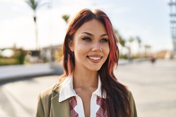 Young caucasian woman smiling confident looking to the side at street