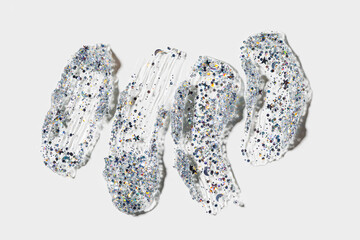 Set cosmetics watches from transparent gel with glitters. Silver glitter for face, body, hair. Shimmer cosmetic gel for festive make up on white background, aesthetic beauty product texture