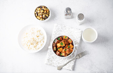 Fototapeta na wymiar Fried Paneer with bowl of rice and eggplants