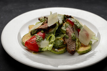 veal salad with baked vegetables and parmesan cheese