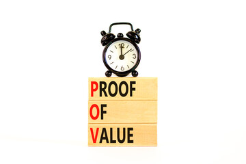 POV Proof of value symbol. Concept words POV Proof of value on beautiful wooden block. Black alarm clock. Beautiful white table white background. Business and POV Proof of value concept. Copy space.