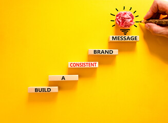 Consistent brand message symbol. Concept words build a consistent brand message on wooden blocks....