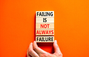 Failure or failing symbol. Concept words Failing is not always failure on wooden block. Beautiful orange table orange background. Businessman hand. Business, failure or failing concept. Copy space.