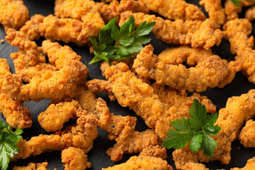 Crispy Shredded Chicken with sweet chilli sauce served on black slate. Party finger food snack concept