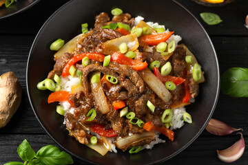 Stir fry Crispy Orange Beef with sweet peppers, onion and rice. Asian food