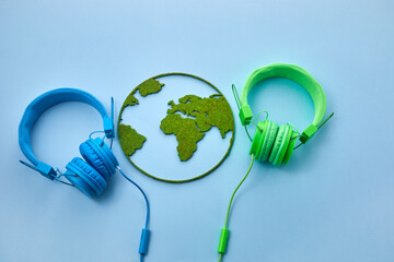 World music day concept. Stereo headphone and a globe on a blue background