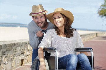 handicapped couple resting on a beach