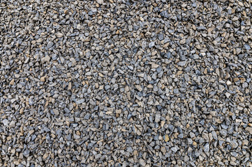Crushed stone as a background. Grey granite gravel background for mix concrete. Construction rock.