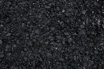 Crushed black stone as a background. Black granite gravel background for mix concrete. Construction...