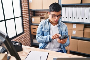 Down syndrome man ecommerce business worker using data phone at office