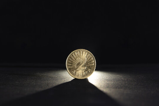 Selective blur on a two denar coin with the mention 2 Denari meaning in Macedonian 2 denars, isolated on a black background. MKD, or Macedonian Denar, is the currency and money of Northern Macedonia.