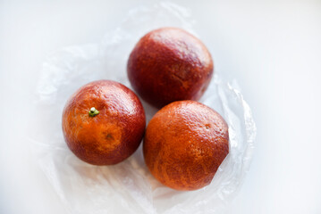 Red oranges on a white background. Juicy fruits. Bright and juicy oranges.