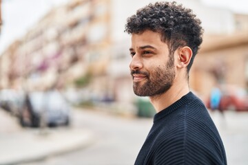 Young arab man smiling confident standing at street