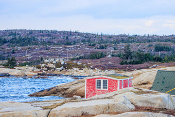 Red house on rocky sea shore