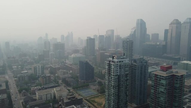 Aerial view of urban Calgary heavy with smoke from massive wildfires in the northern boreal forest. 
