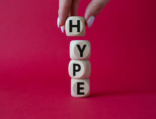 Hype symbol. Concept word Hype on wooden cubes. Businessman hand. Beautiful red background. Business and Hype concept. Copy space.