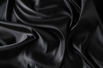 Fototapeta premium Silk fabric, abstract wavy black satin fabric background.