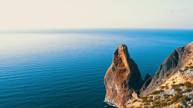Beautiful seascape. Blue sea or ocean with rocks on a sunny day. 4K