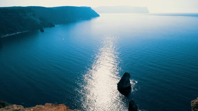 Beautiful seascape. Blue sea or ocean with rocks on a sunny day. 4K