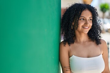 Fototapeta premium Young hispanic woman smiling confident looking to the side at street