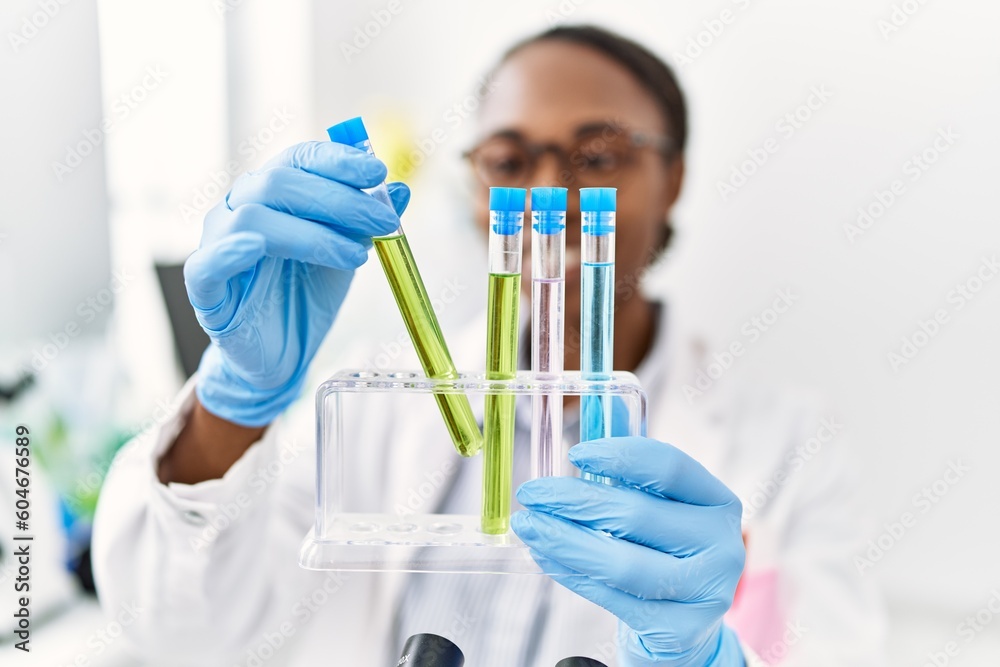 Canvas Prints African american woman scientist holding test tubes at laboratory