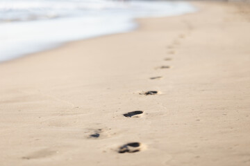 Fototapeta na wymiar footprints on the wet sand