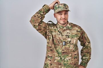 Young hispanic man wearing camouflage army uniform confuse and wonder about question. uncertain...