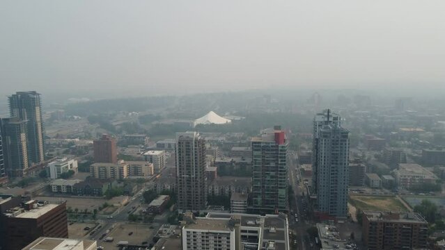Aerial view of urban Calgary heavy with smoke from massive wildfires in the northern boreal forest. 