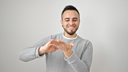 Hispanic man smiling confident doing spend money gesture over isolated white background