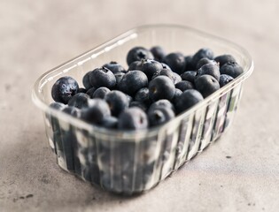  Delicious group of blueberries on plastic box marble surface