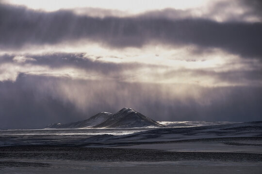 Sunlight through clouds in a snowstorm over a remote landscape, Iceland