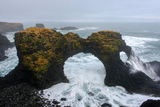 Waves breaking on Gatklettur (Hellnar Arch), Arnastapi, Snaefellsnes Peninsula, Iceland