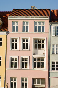 Pink historic terraced house in Nyhavn in the center of Copenhagen in Denmark