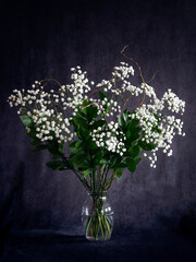 bouquet of white spring flowers on a dark background